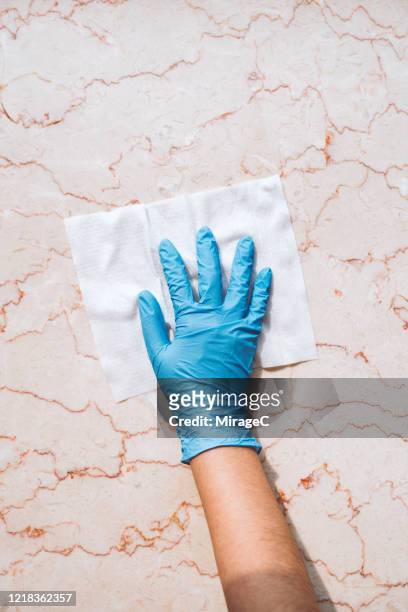 cleaning marble surface by using disposable wet wipes - surgical glove stock pictures, royalty-free photos & images