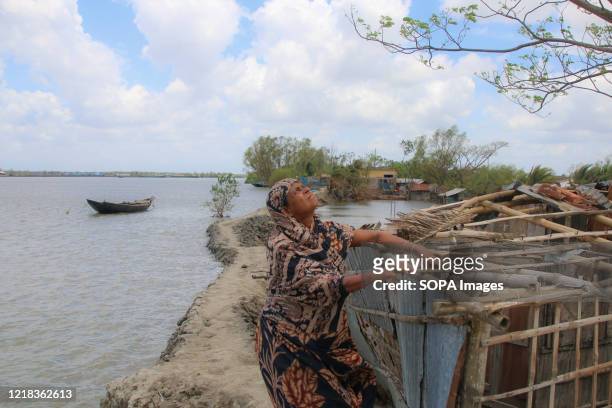 Helpless woman puzzled after losing her house after the landfall of cyclone Amphan. Thousands of shrimp enclosures have been washed away, while...