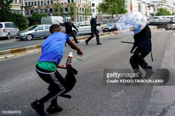 Protestor scuffle with Police officers in riot gear during an anti-racism protest, in Brussels, on June 7 as part of a weekend of 'Black Lives...