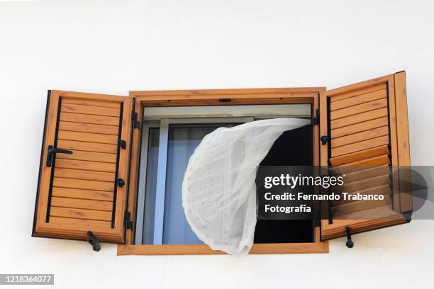 curtain on a window moved by the wind - curtains blowing stock pictures, royalty-free photos & images