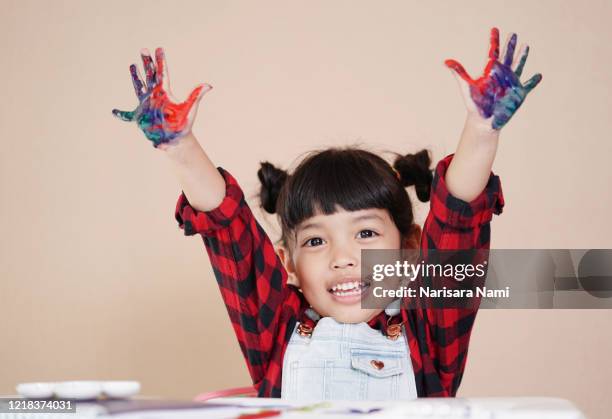 little asian child girl with colorful hands painted. creative kid girl love art concept. - body art painting fotografías e imágenes de stock