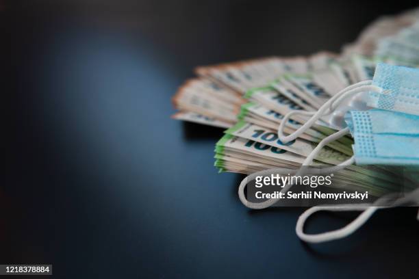 euro banknotes and pills, on black background, concept of treatment costs, paid medicine, mask for respiratory protection. virus protection. health care reform. copy space, place for text - coronavirus money stock pictures, royalty-free photos & images
