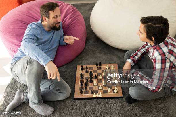 traditional family playing chess during day in ramadan - two young arabic children only indoor portrait stock pictures, royalty-free photos & images