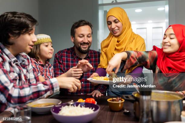 family eating iftar and enjoying breaking of fasting - イフタール ストックフォトと画像