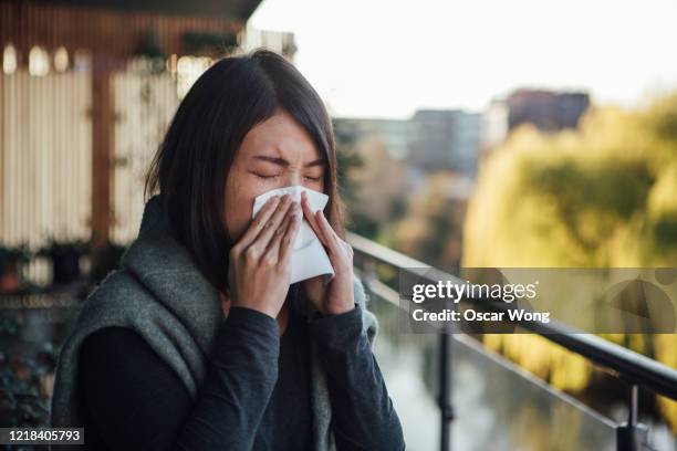 sick young woman blowing nose - japanese handkerchief stock pictures, royalty-free photos & images