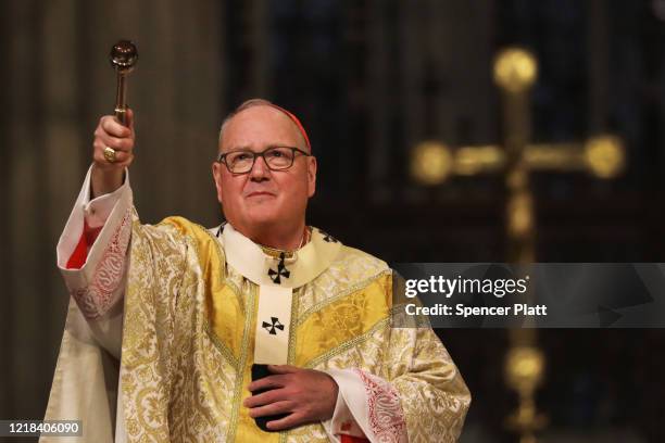 Cardinal Timothy Dolan, the Archbishop of New York, celebrates Easter Sunday Mass in a nearly empty St. Patrick’s Cathedral as the coronavirus...