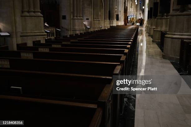 Church pews stand empty as Cardinal Timothy Dolan, the Archbishop of New York, celebrates Easter Sunday Mass in a nearly empty St. Patrick’s...