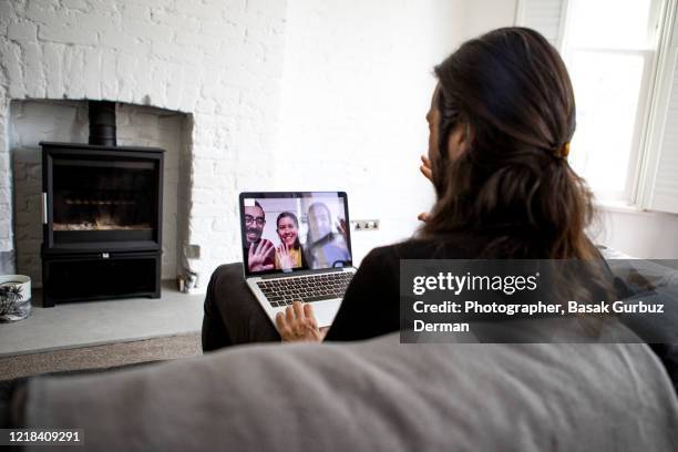 teleconference / video conference with friends - lockdown uk stock pictures, royalty-free photos & images
