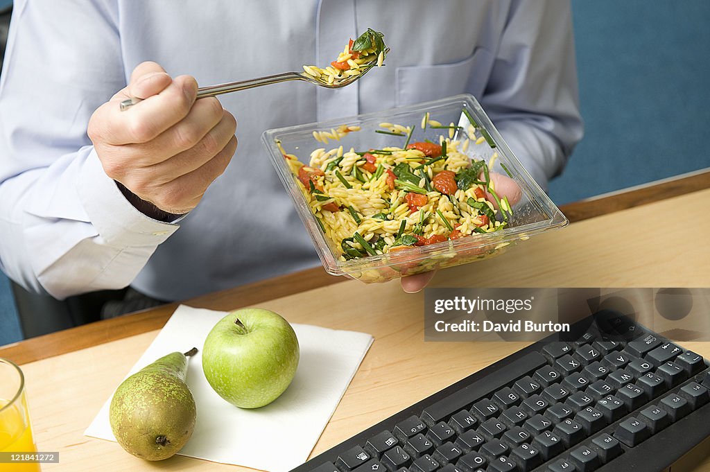 Man eating lunch at work