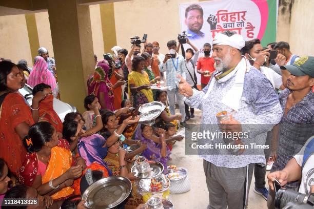 Jan Adhikar Party president Pappu Yadav distributes utensils to people in need during Bihar Bacha Lo Mauka Hain campaign at his residence, on June 7,...