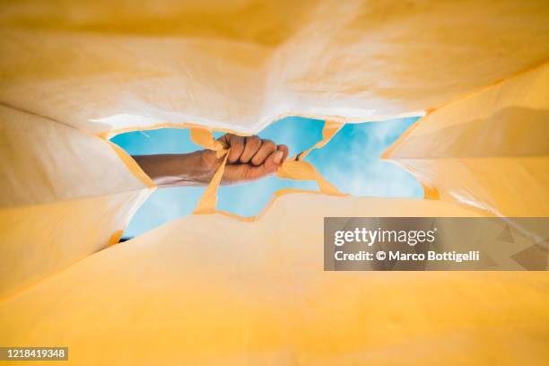 human hand holding a yellow shopping bag - supermarket interior stock pictures, royalty-free photos & images