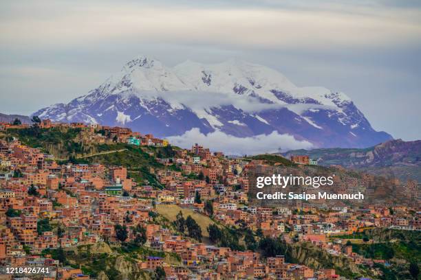 cityscape of la paz with illimani mountain rising in the background, bolivia - potosi bolivia stock pictures, royalty-free photos & images