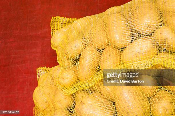potatoes in nylon sacks, turin, italy - potatoes in a sack stock-fotos und bilder