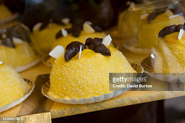 cakes in a bakery window (polenta e osei) - polenta fotografías e imágenes de stock