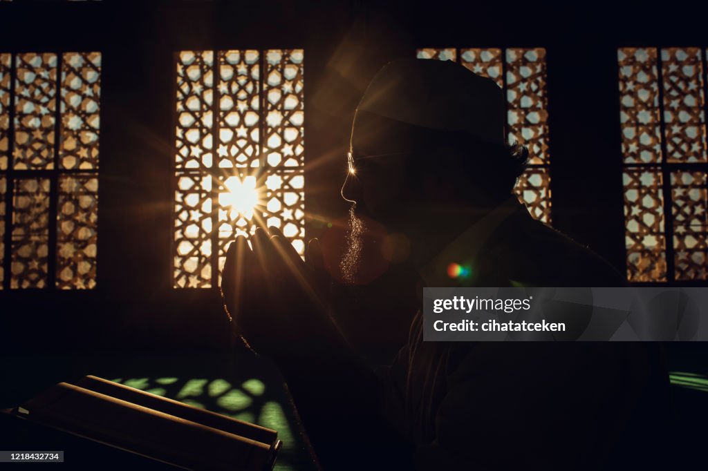 Muslim man is praying in mosque