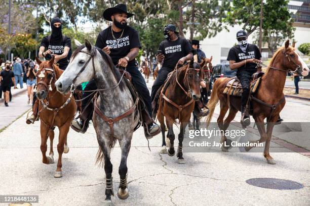 The Compton Cowboys, with Randy Savvy riding lead, second from left, arrive at Gateway Towne Center, for the start of their Peace Ride, culminating...