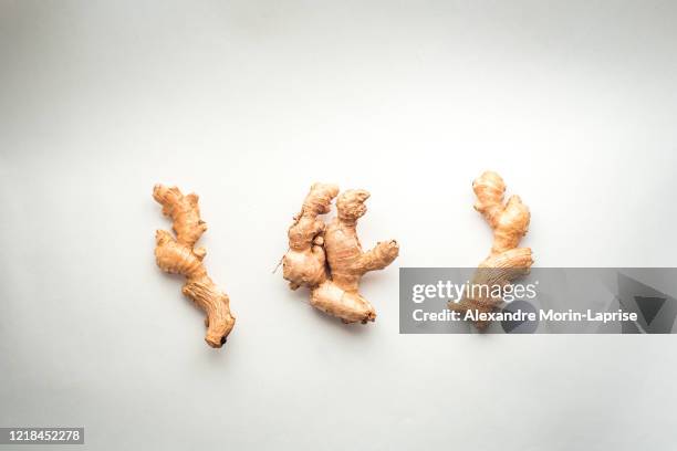 three pieces of ginger on a white background - ginger tea stock pictures, royalty-free photos & images