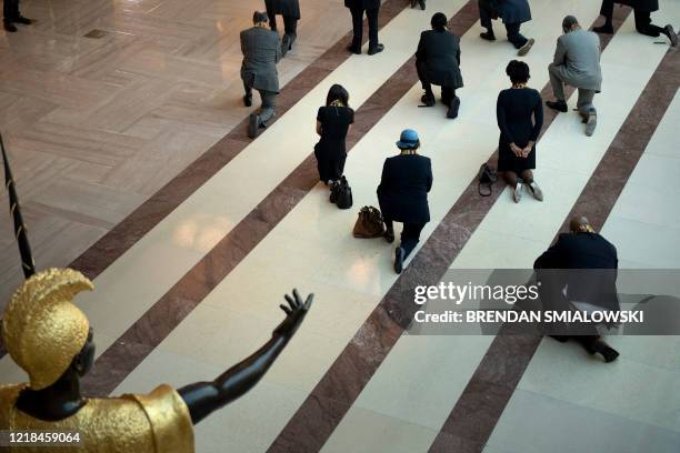 Statue of King Kamehameha I is seen as Democratic lawmakers take a knee to observe a moment of silence on Capitol Hill for George Floyd and other...