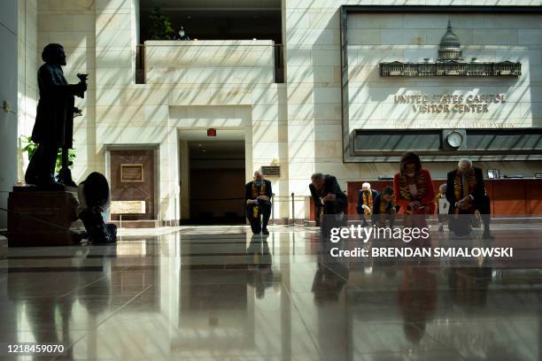 Statue of escaped slave Frederick Douglass is seen as Democratic lawmakers take a knee to observe a moment of silence on Capitol Hill for George...