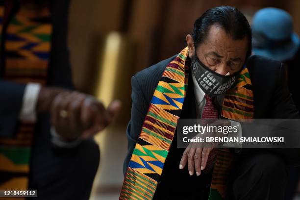 Rep. Al Green and other Democratic lawmakers take a knee to observe a moment of silence on Capitol Hill for George Floyd and other victims of police...