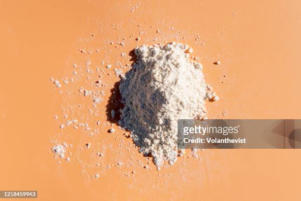 white wheat flour bag on light orange background - gemahlen stock-fotos und bilder
