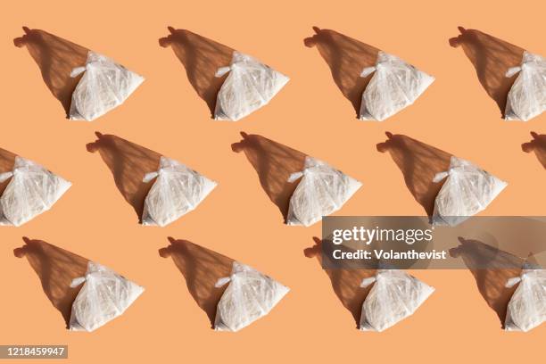 white wheat flour bag on light orange background - flour bag stockfoto's en -beelden