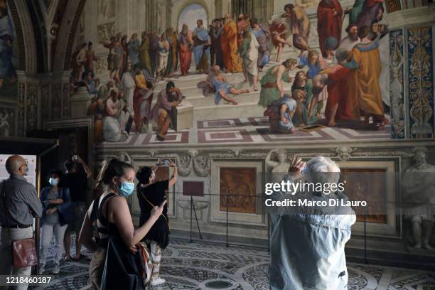 Visitors are seen in one of the four rooms of Raphael that called "della Segnatura" in front of the fresco "The school of Athens at the Vatican...