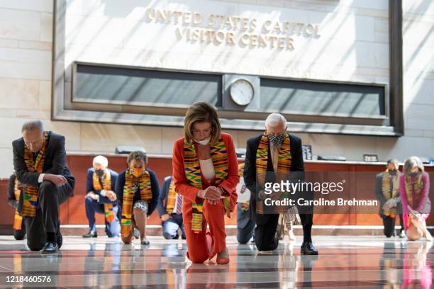 Speaker of the House Nancy Pelosi, D-Calif., and other members of Congress gather at the Emancipation Hall, kneel as they take moment of silence to...