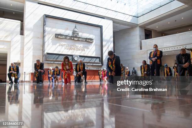 Speaker of the House Nancy Pelosi, D-Calif., and other members of Congress gather at the Emancipation Hall, kneel as they take moment of silence to...