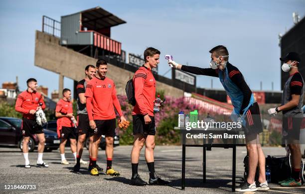 Dublin , Ireland - 8 June 2020; Paddy Kirk has his temperature taken by Aaron Fitzsimons, Equipment Manager, as his team-mates wait in line, ahead of...