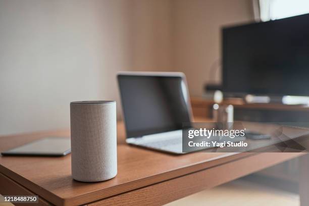 working from home and using a smart speaker - bluetooth stock pictures, royalty-free photos & images