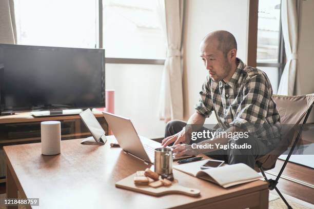 asian male worker working from home. - house science stock pictures, royalty-free photos & images