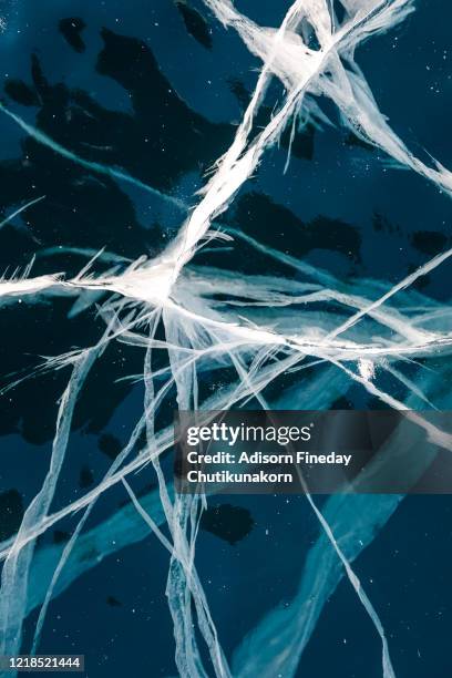 texture of ice of baikal lake in siberia with ice crack - ice crack stock-fotos und bilder