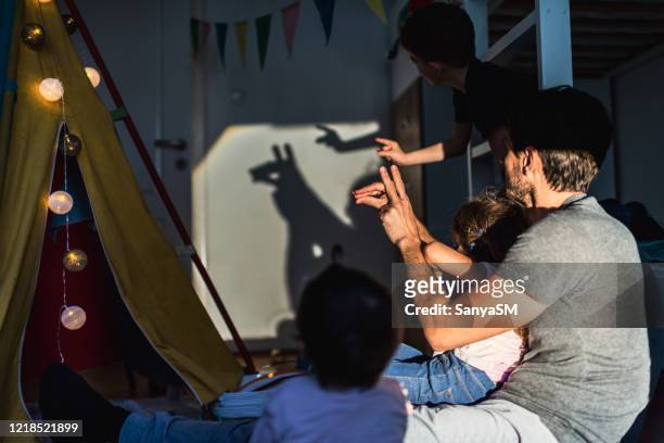 storytelling in children's room - shadow puppets stock pictures, royalty-free photos & images