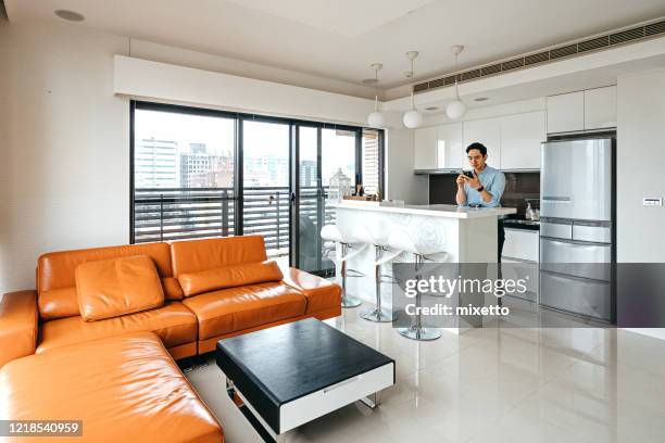 man using mobile phone in kitchen - letter l stock pictures, royalty-free photos & images