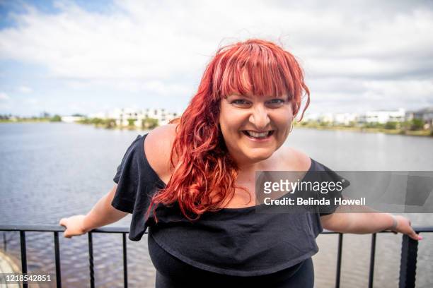 confident, plus sized women with a positive body image - dyed red hair stock-fotos und bilder