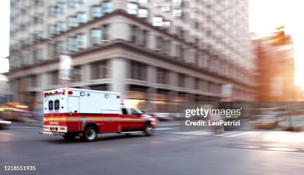 ambulance respond to an emergency in downtown - emergency medicine stock pictures, royalty-free photos & images