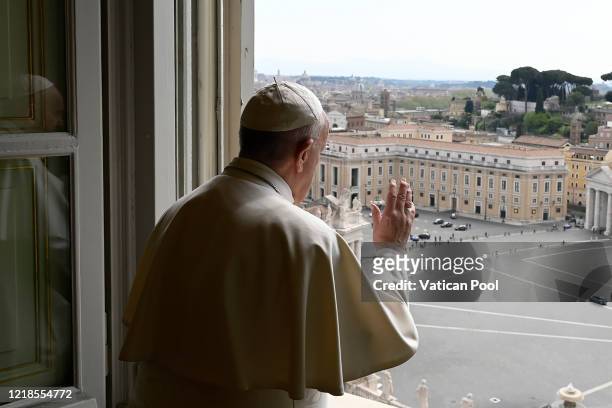 Pope Francis delivers his blessing after the recitation of the Regina Caeli from the window of his private library overlooking an empty St. Peter's...