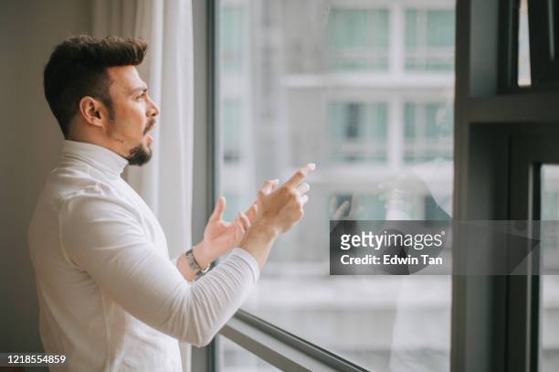 a middle eastern man talking to the window with digital screen displayed practicing presentation preparation - practicing stock pictures, royalty-free photos & images