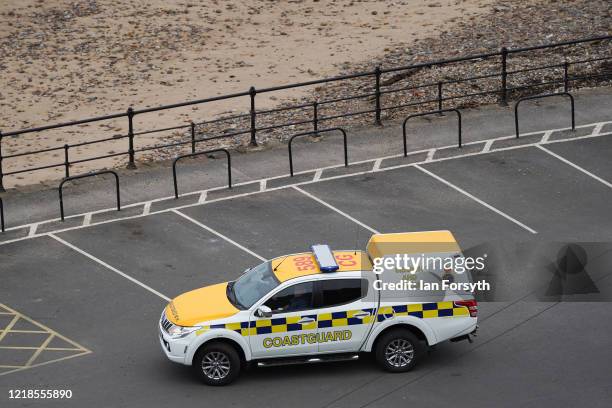 Coastguard patrol drives through an empty car park on Saltburn lower promenade as visitors take notice of lockdown restrictions and stay away on...