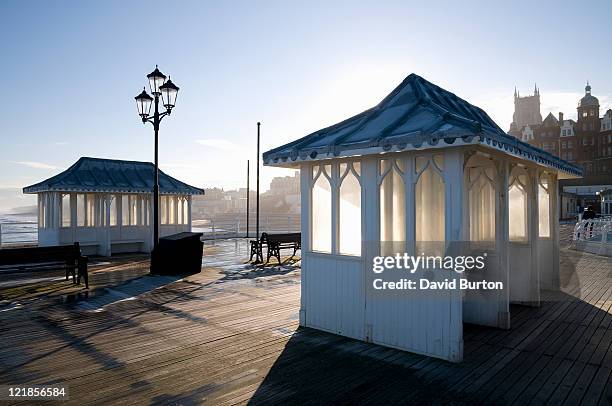 sheltered seating on cromer pier, norfolk, uk - cromer pier stock pictures, royalty-free photos & images