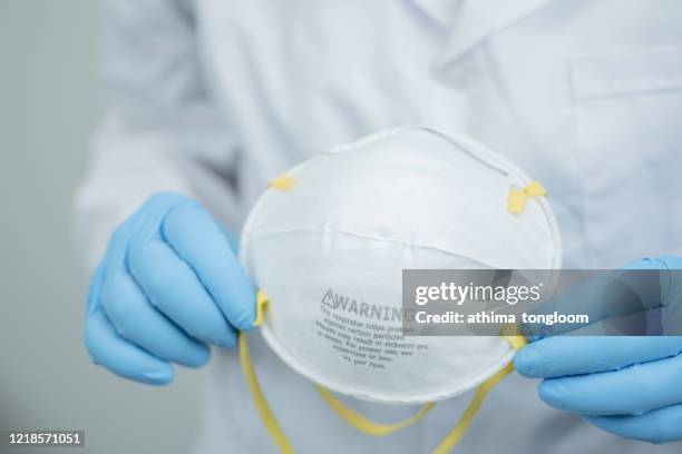 view of hands holding pm 2.5 face protection mask and ready to ware - air respirator mask stock pictures, royalty-free photos & images