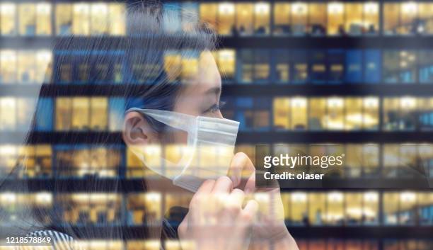 asian woman with face mask going back to work, business building reflecting - coronavirus office stock pictures, royalty-free photos & images