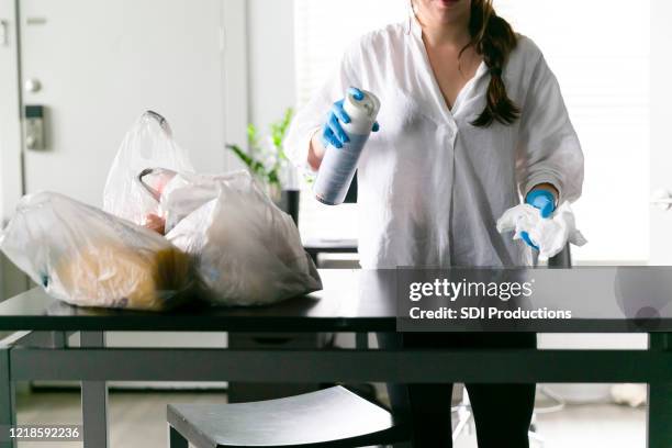 woman sprays table with disinfectant - aerosol can stock pictures, royalty-free photos & images