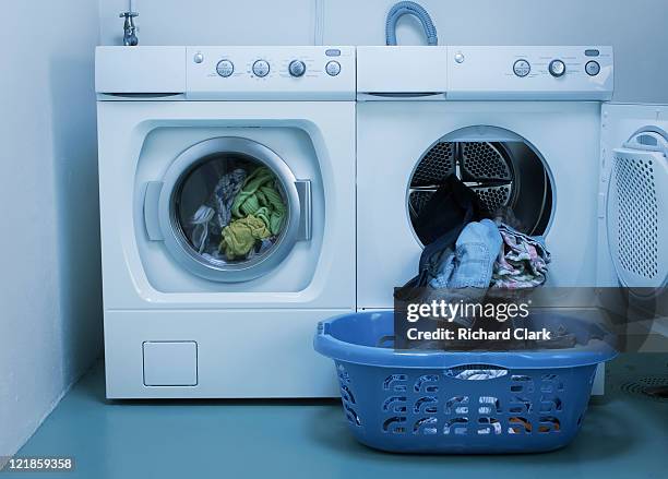 domestic energy waste: use of washing machine and tumble drier - washing machine stock pictures, royalty-free photos & images