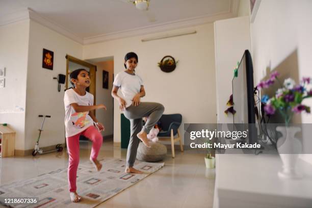 mother and daughter exercising in the living room - smart tv living room stock pictures, royalty-free photos & images