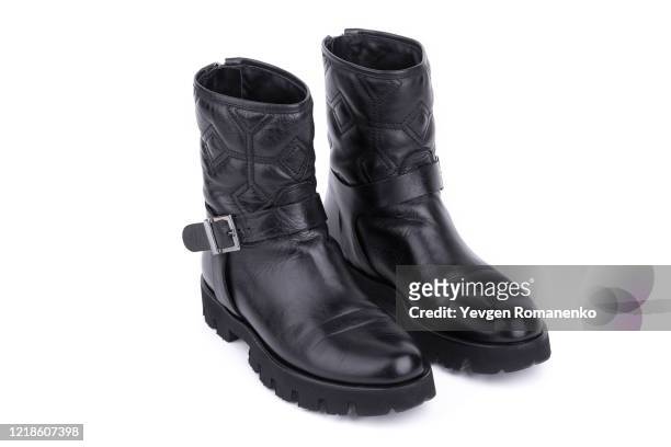 pair of black leather boots isolated on white background - metallic shoe stock pictures, royalty-free photos & images