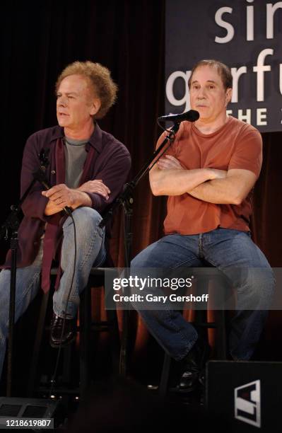 American Folk musicians Art Garfunkel and Paul Simon, who performed together as the duo Simon & Garfunkel, speak onstage during a press conference at...