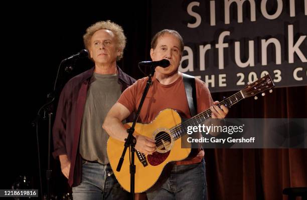 American Folk musicians Art Garfunkel and Paul Simon perform together, as the duo Simon & Garfunkel, onstage during a press conference at the Bottom...