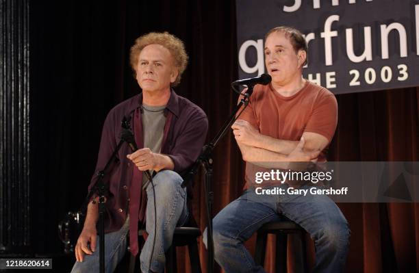 American Folk musicians Art Garfunkel and Paul Simon, who performed together as the duo Simon & Garfunkel, speak onstage during a press conference at...